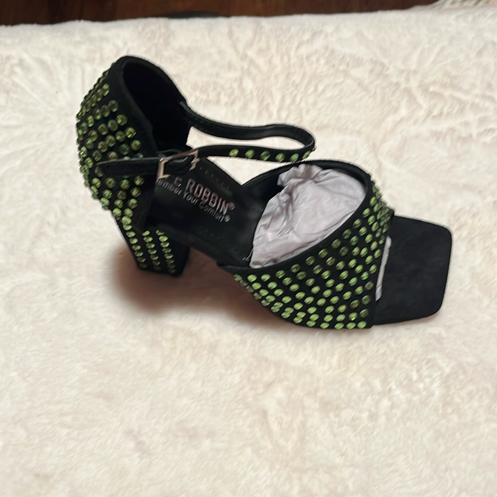 Black heels with green stones.